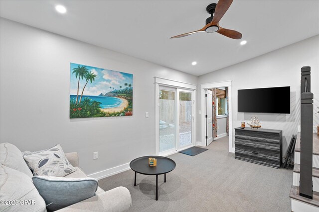 carpeted living room featuring vaulted ceiling and ceiling fan