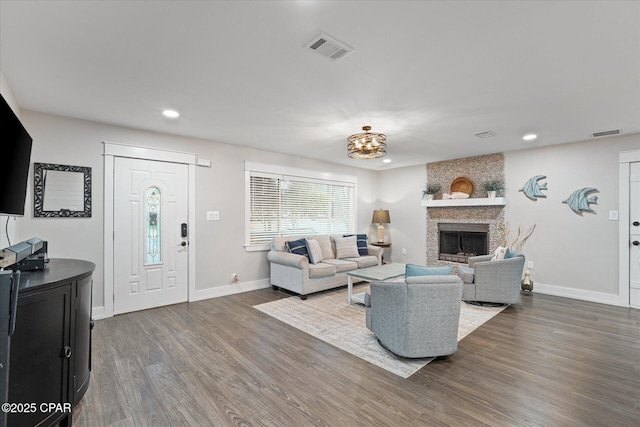 living room with a fireplace and dark hardwood / wood-style floors