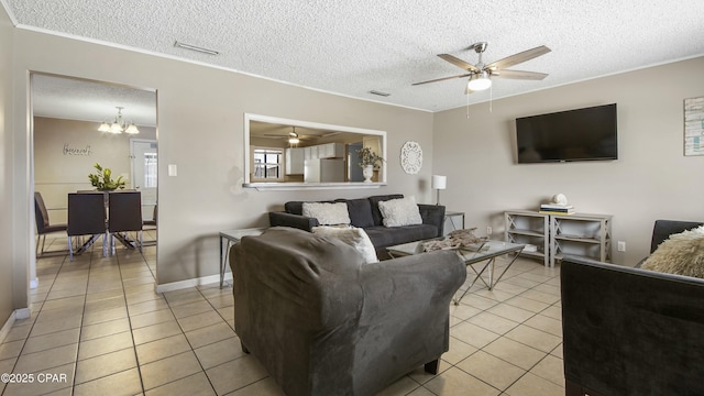 tiled living room with crown molding, ceiling fan with notable chandelier, and a textured ceiling