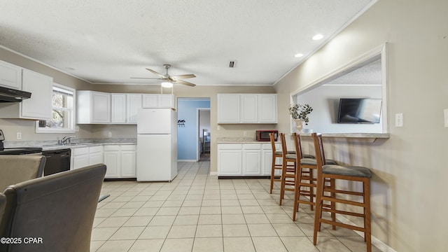 kitchen with white fridge, black dishwasher, white cabinets, and ceiling fan