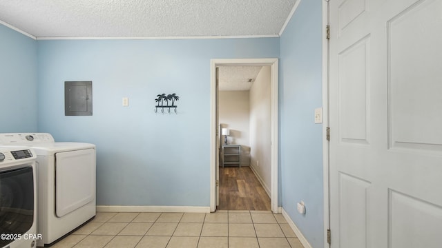 laundry area featuring separate washer and dryer, electric panel, a textured ceiling, and light tile patterned floors