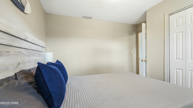 bedroom with a closet and a textured ceiling