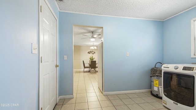 washroom featuring crown molding, washer / dryer, light tile patterned floors, and a textured ceiling