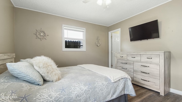 bedroom with dark wood-type flooring, ornamental molding, and a textured ceiling