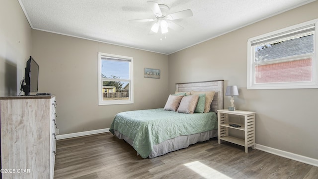 bedroom with hardwood / wood-style floors, ornamental molding, a textured ceiling, and ceiling fan