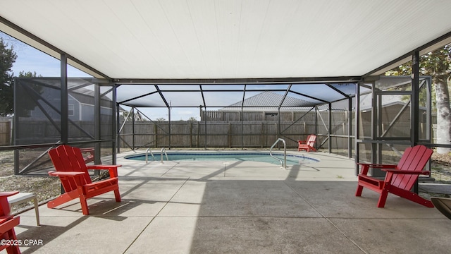 view of swimming pool featuring glass enclosure and a patio area