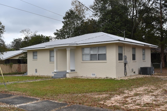 bungalow-style home with cooling unit, crawl space, metal roof, a front yard, and fence
