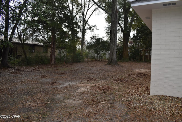 view of yard with visible vents and fence