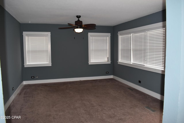 unfurnished room featuring visible vents, baseboards, a ceiling fan, and carpet flooring