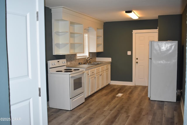 kitchen featuring dark wood finished floors, white appliances, open shelves, a sink, and backsplash