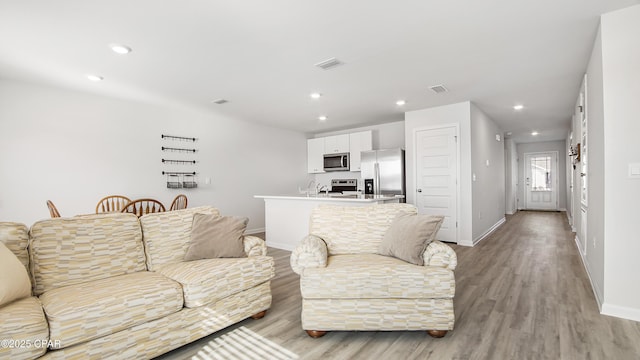 living room with light hardwood / wood-style floors