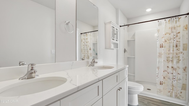 bathroom with a shower with curtain, vanity, toilet, and wood-type flooring