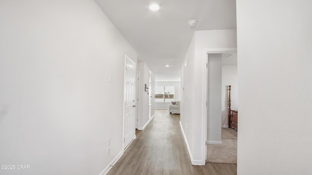 hallway with light hardwood / wood-style flooring