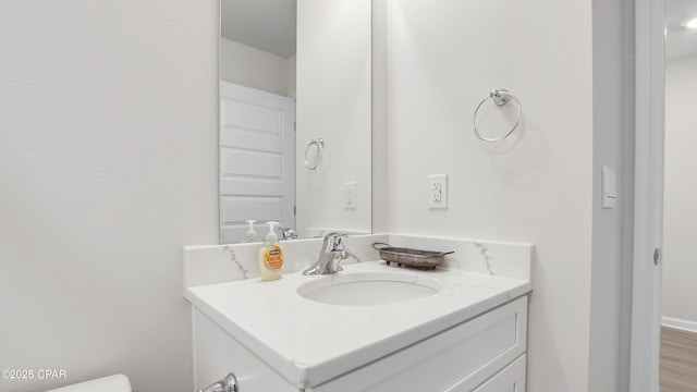 bathroom featuring vanity and hardwood / wood-style floors