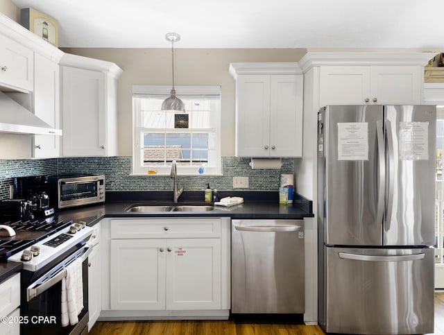 kitchen with backsplash, appliances with stainless steel finishes, sink, and white cabinets