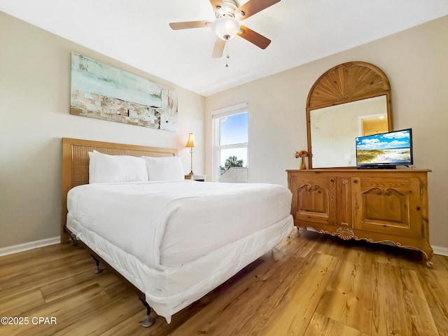 bedroom with light hardwood / wood-style flooring and ceiling fan