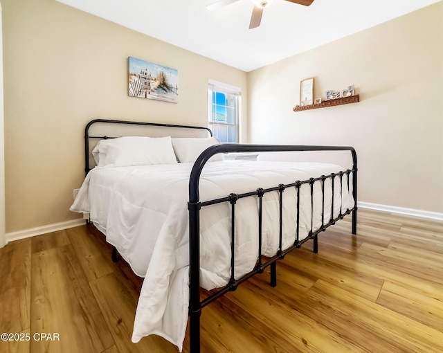 bedroom with hardwood / wood-style flooring and ceiling fan