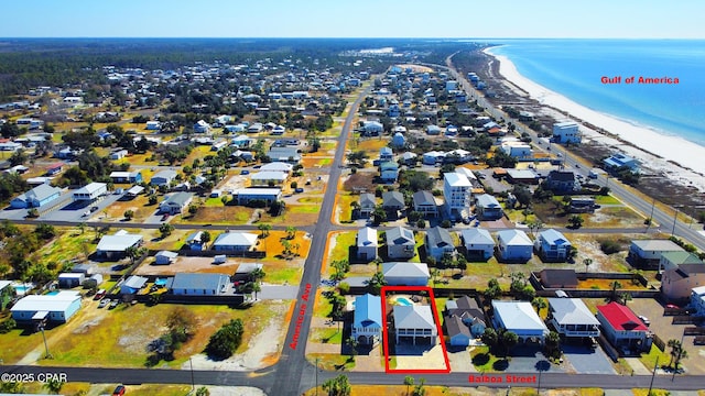 birds eye view of property with a beach view and a water view