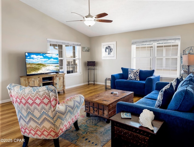 living room with hardwood / wood-style floors, vaulted ceiling, and ceiling fan