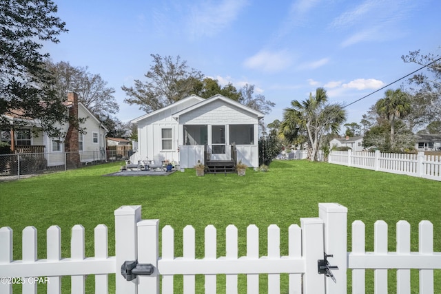 view of front of property featuring a front lawn and a sunroom