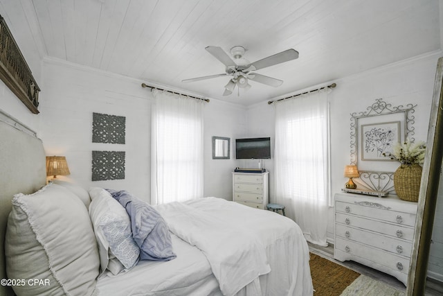 bedroom featuring crown molding, ceiling fan, wood ceiling, and multiple windows