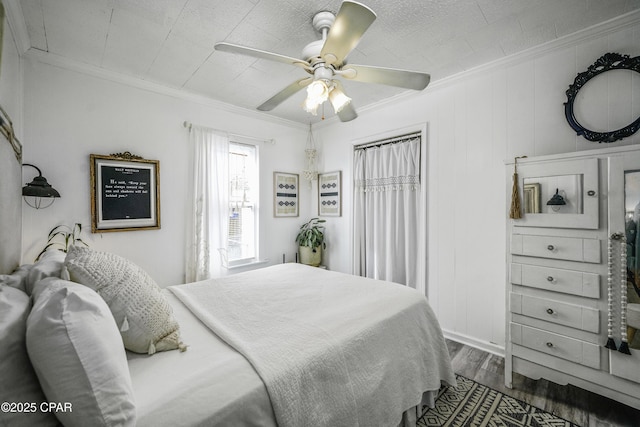 bedroom featuring crown molding, wood-type flooring, and ceiling fan