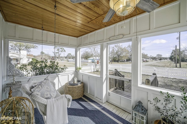 sunroom / solarium featuring wood ceiling and plenty of natural light