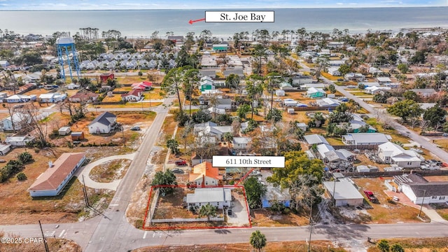 birds eye view of property with a water view