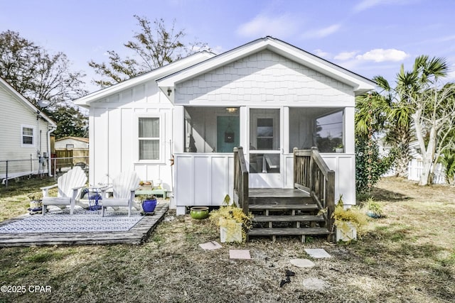 back of house featuring a sunroom