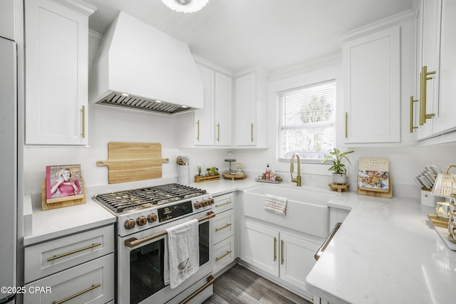 kitchen featuring white cabinetry, premium range hood, and appliances with stainless steel finishes