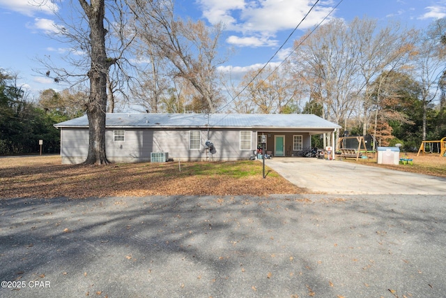 single story home featuring a carport and a playground