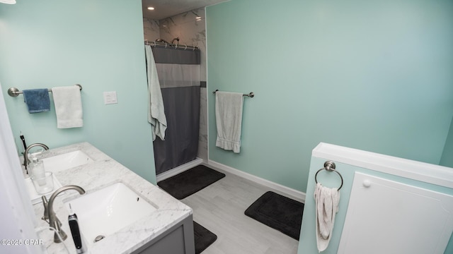 bathroom featuring vanity, a shower with shower curtain, and hardwood / wood-style floors