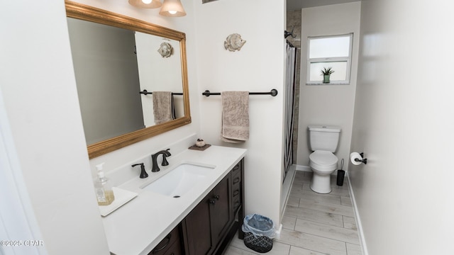 bathroom with vanity, toilet, and walk in shower