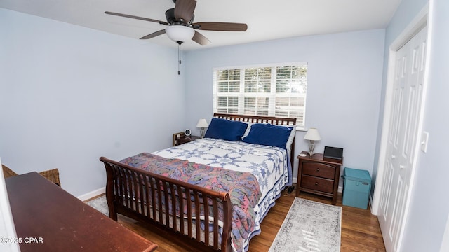 bedroom featuring hardwood / wood-style flooring, ceiling fan, and a closet