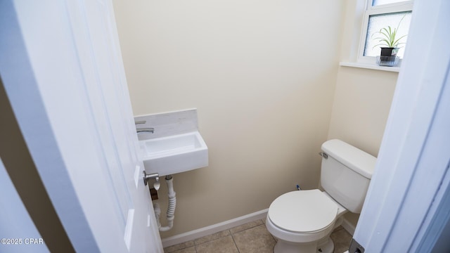 bathroom with sink, tile patterned floors, and toilet