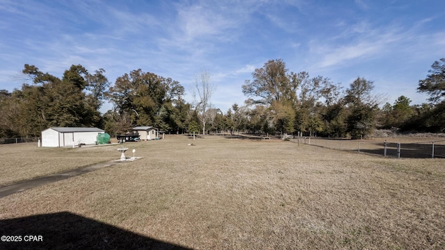 view of yard with a storage shed and a rural view