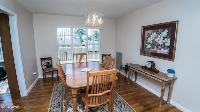 dining room featuring an inviting chandelier and dark hardwood / wood-style flooring