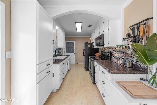 kitchen with sink, tasteful backsplash, black appliances, ornamental molding, and white cabinets