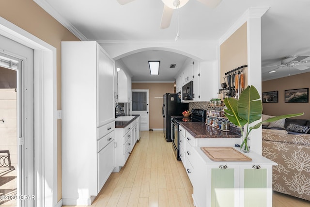 kitchen featuring sink, ornamental molding, black appliances, and white cabinets