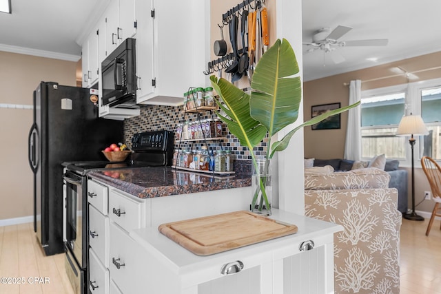 kitchen with crown molding, tasteful backsplash, black appliances, light hardwood / wood-style floors, and white cabinets