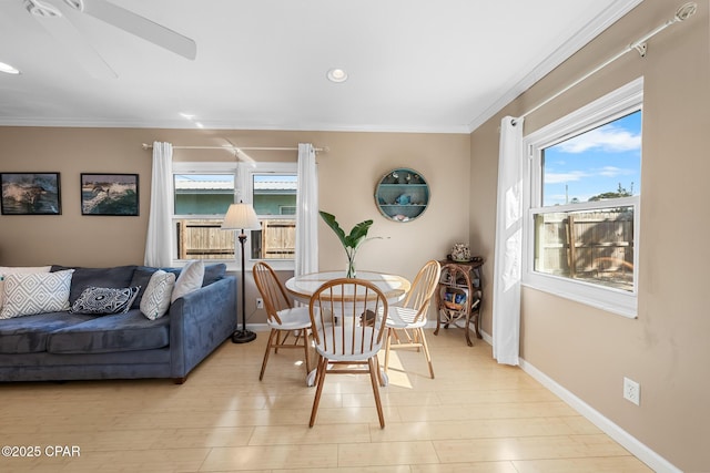 dining area with light hardwood / wood-style flooring, plenty of natural light, and ornamental molding