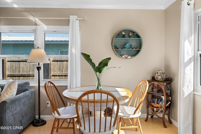 21823 Marlin Ave, Panama City Beach, FL 32413 - dining room featuring baseboards, wood finished floors, and crown molding