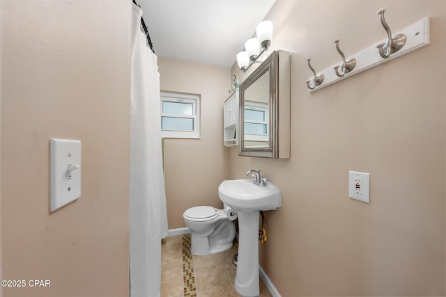 bathroom with tile patterned flooring, sink, and toilet