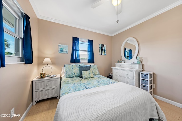 21823 Marlin Ave, Panama City Beach, FL 32413 - bedroom featuring baseboards, ornamental molding, light wood finished floors, and a ceiling fan