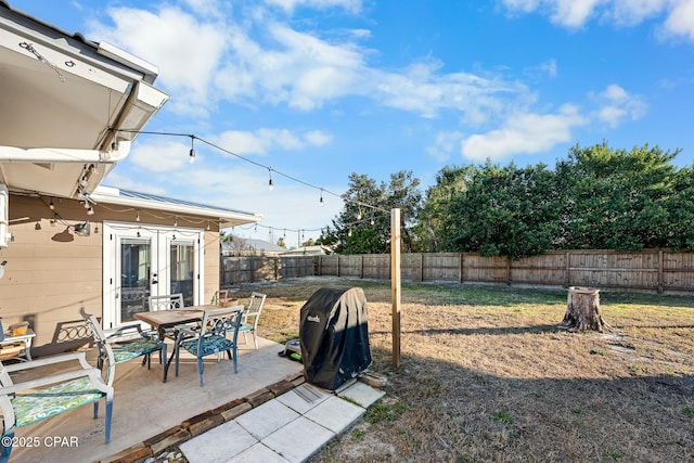 view of yard featuring french doors and a patio area