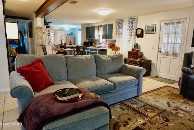 living room with light tile patterned floors and sink