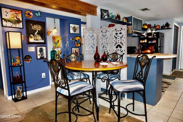 tiled dining area featuring indoor bar