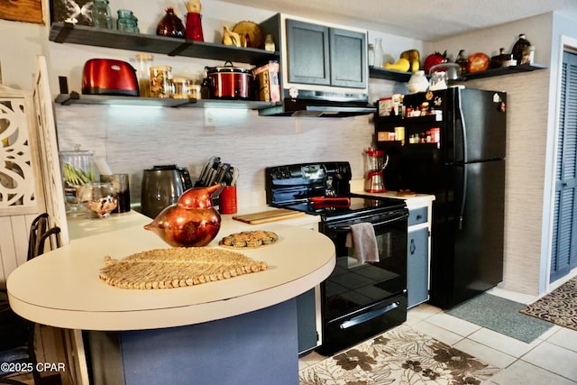 kitchen with light tile patterned floors, ventilation hood, and black appliances