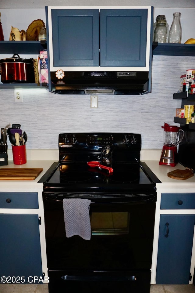 kitchen with black / electric stove, decorative backsplash, and blue cabinetry