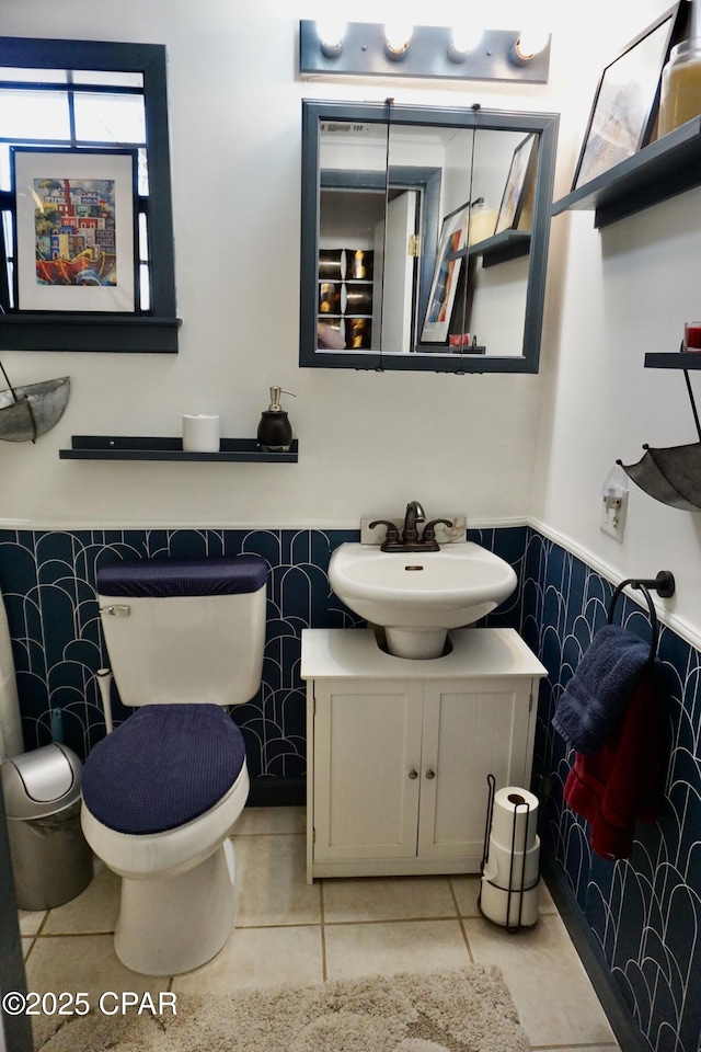 bathroom featuring vanity, tile patterned flooring, tile walls, and toilet